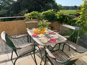 a wooden table with chairs and drinks on a patio at Ferienwohnung am Maximilianpark Hamm in Hamm