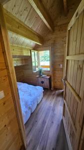 a large room with a bed in a wooden cabin at Poloniny Osadne in Osadné +13 photos