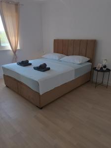 a bedroom with a bed with two towels on it at Apartman Sara in Ljubuški