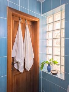 a bathroom with a door with towels hanging on it at Casa de pe colț in Orăştie