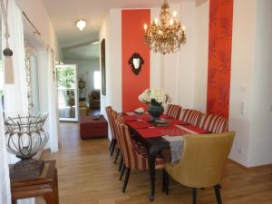a dining room with a black table and chairs at Deluxe Loft Mountain View in Bad Reichenhall
