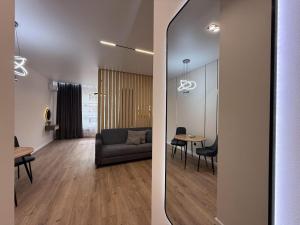 a living room with a couch and a table at Уютная в центре города in Zhezdi