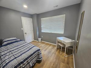 a bedroom with a bed and a table and a window at Cozy place! in Baltimore