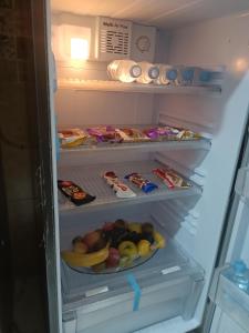 an open refrigerator filled with lots of food and fruit at plage Taït club omeGa in Andalouciene +7 photos