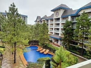 an aerial view of a resort with a swimming pool at Cozyluxe at Pine Suites Tagaytay in Kaybagal