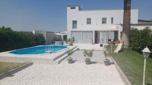 a house with a swimming pool in the yard at B&B Le perle fg in Marconia