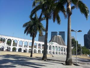 a building with palm trees in front of it at LOFT LAPA Baldô in Rio de Janeiro