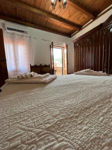 a large bed in a room with a window at Casa Meri in Villagrande Strisaili