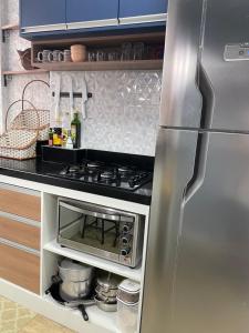 Η κουζίνα ή μικρή κουζίνα στο Apart Ponta da Praia - Santos