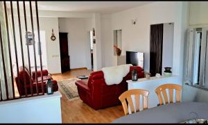 a living room with a red chair and a couch at Villa Alpine in Valjiosi