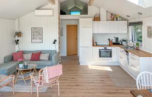 a kitchen and living room with a couch and a table at Nice Home In Kalundborg in Kalundborg