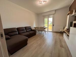 a living room with a couch and a table at Kìbilù Comfort Hub Malpensa in Cardano al Campo +28 photos