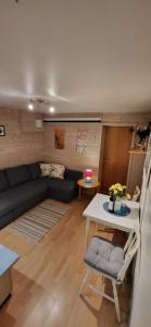 a living room with a couch and a table at Marias Guesthouse in Tromsø +12 photos