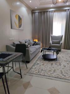 a living room with a couch and a table at وادي العقيق 202 in Al Madinah