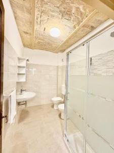 a bathroom with a shower and a toilet and a sink at Casa Pastore 01 in Caramanico Terme +4 photos