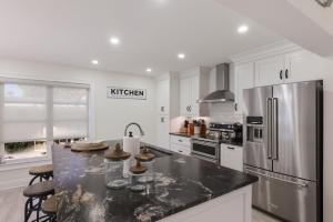 a kitchen with a refrigerator and a counter top at Surf Riders home in Holmes Beach