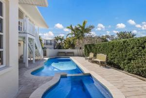 a swimming pool in the backyard of a house at Surf Riders home in Holmes Beach