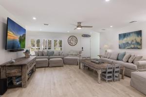 a living room with a couch and a table at Surf Riders home in Holmes Beach +38 photos