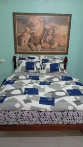 a bedroom with a bed with a painting on the wall at Recanto Marina in Paraty
