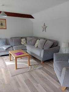 a living room with a couch and a coffee table at Swallow cottage in Louth