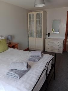 a bedroom with a bed with towels on it at Swallow cottage in Louth