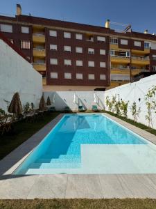 an empty swimming pool in front of a building at Casa Ribera Maya in Aranda de Duero