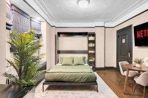 a bedroom with a bed and a table at Unbeatable Location The Heart of NYC 1 BDR W GYM in New York