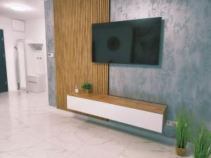 a living room with a tv on a wall at Aura Apartamenty in Brzeg