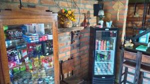 a room with a refrigerator and a brick wall at Hotel Posada La Porra in Concordia