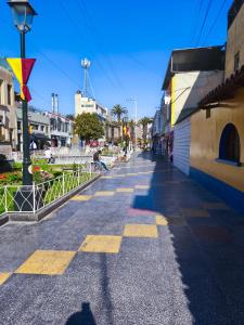 a shadow of a person walking down a street at Minidepartamento en el centro de Tacna in Tacna