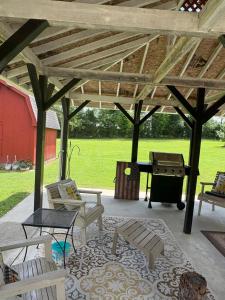 a pavilion with chairs and a grill on a patio at Sonnys place in Washington