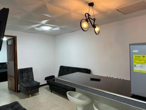 a meeting room with a long table and chairs at Apartamentos FM 212 in Líbano +3 photos