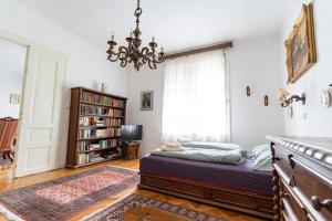 a bedroom with a bed and a chandelier at Romantic Villa - Pápa in Pápa