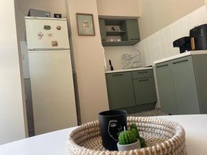 a kitchen with a table with a basket of cactus at KudevApartment1 in Nesebar