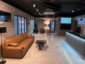 a living room with a couch and a table at Apartment, premium class, near the sea 1718 batumi in Batumi