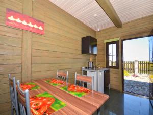 a kitchen with a wooden table with peppers on it at Family Baltic Getaway in Cisowo