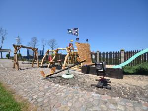 a playground with a slide and a swing set at Family Baltic Getaway in Cisowo