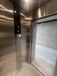 a shower with a glass door in a bathroom at Apartment, premium class, near the sea 1718 batumi in Batumi +11 photos