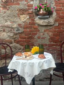 a table with bread and drinks on top of it at La casetta della nonna in Camagna Monferrato