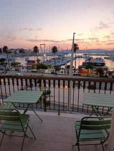 a patio with two tables and chairs and a harbor at L'Aragosta Guesthouse in Alghero