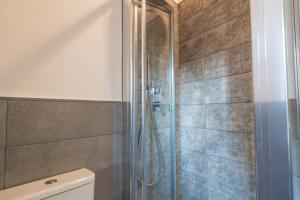 a bathroom with a shower and a toilet at Alcantara Domus in Roccella Valdemone +42 photos