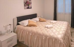 a bedroom with a bed with two towels on it at Three-Bedroom Holiday Home In Vinjani Gornji in Aračići