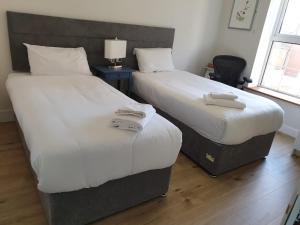ダブリンにあるLuxury Custom Hall City Apartmentの部屋に並んで置かれた2つのベッド