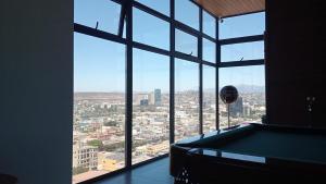 a large window in a building with a view of a city at Penthouse Av Revolution in Tijuana