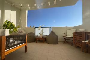 a living room with pillows and a blue light at Nàlua Sardinia Experience in Quartu SantʼElena