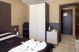 a bedroom with a bed and a sliding glass door at Aparthotel Paradiso in Nesebar