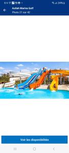a water park with a slide in a swimming pool at Bel appartement dans un complexe prestigieux Marina Golf in Asilah +23 photos