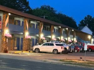 a car parked in front of a building at night at Kewanee Motor Lodge in Kewanee +8 photos