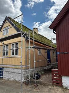 a house being built with a scaffolding at Beautifully restored traditional home in old town Tórshavn in Tórshavn