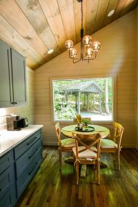 a kitchen with a table and chairs and a window at Peach and Plumeria Hideaway in Cherry Log